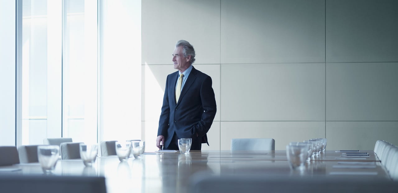 Businessman standing alone in conference room